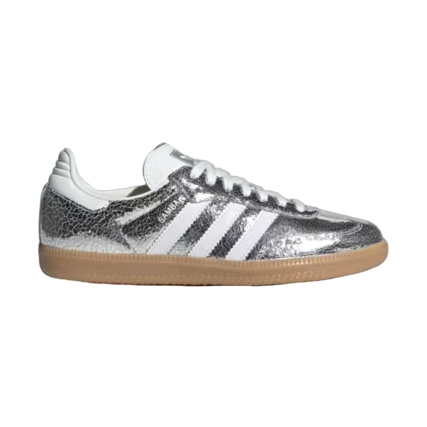 Silver Adidas sneaker with white stripes on a light gray background
